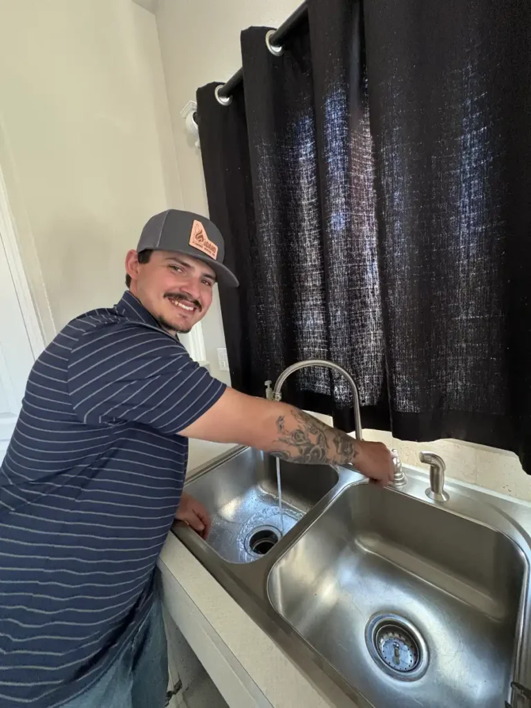 A man standing in front of a sink.